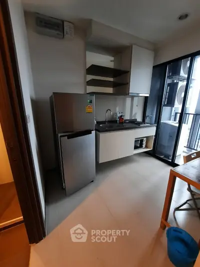 Modern compact kitchen with sleek appliances and open layout in urban apartment