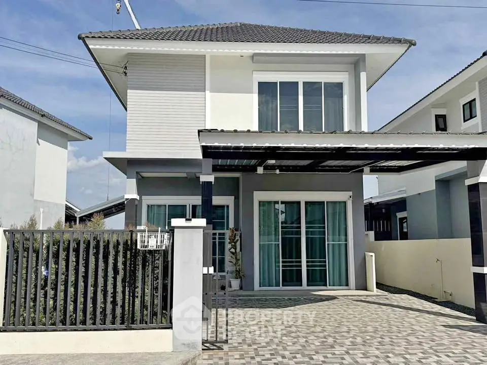 Modern two-story house with sleek design and spacious driveway