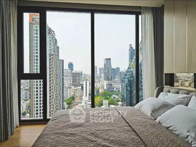 Luxurious bedroom with stunning city skyline view through large windows, offering a serene urban retreat.
