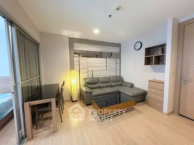 Modern living room with sleek furniture and wooden flooring in a cozy apartment.