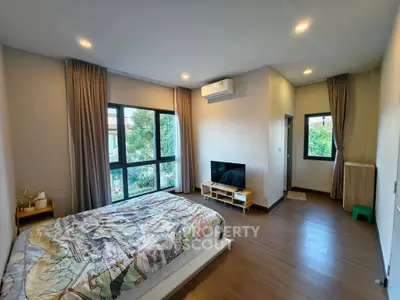 Spacious bedroom with large windows and modern decor