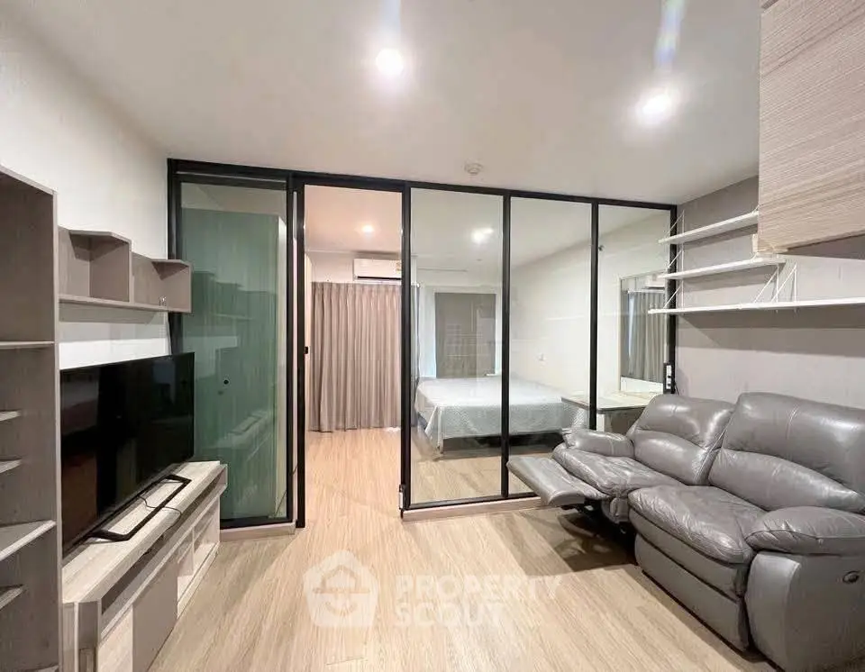 Modern living room with glass partition and cozy leather sofa