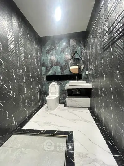Luxurious modern bathroom with marble walls and sleek fixtures
