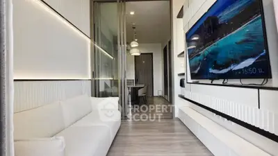 Modern living room with sleek design and wall-mounted TV, featuring elegant lighting and contemporary furniture.