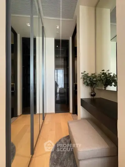 Elegant hallway with mirrored closets and stylish decor in modern apartment