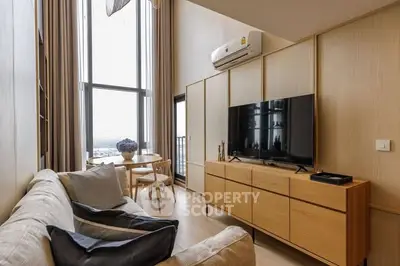 Modern living room with large windows and stylish furniture