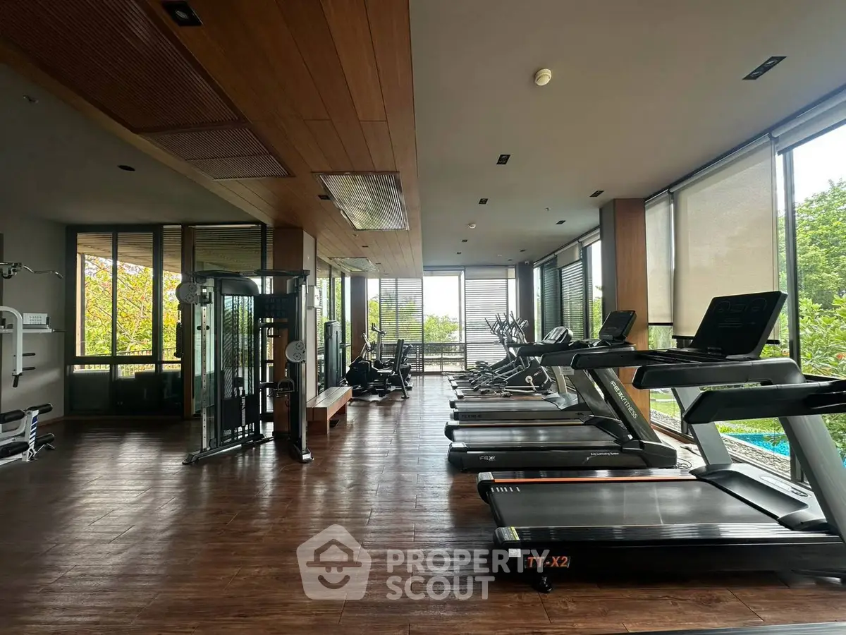 Spacious modern gym with state-of-the-art equipment and scenic views.