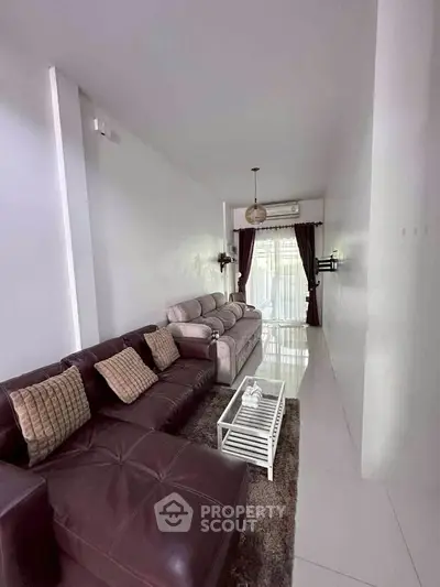 Stylish living room with modern furniture and elegant decor, featuring a cozy seating area and natural light.