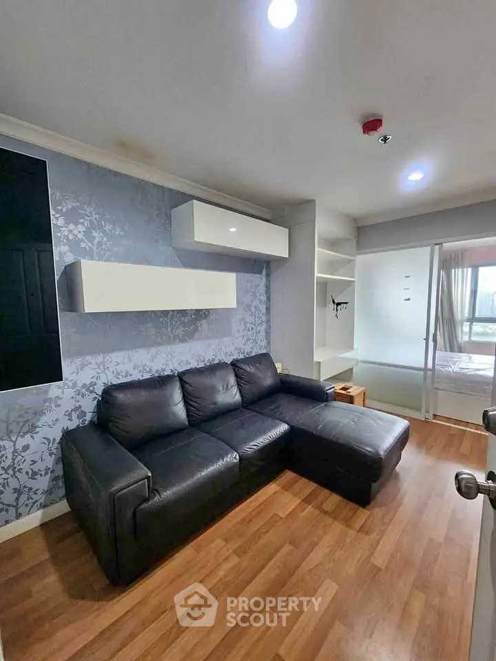 Modern living room with black leather sofa and stylish decor