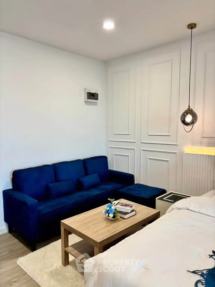 Chic modern living room with blue sofa and elegant lighting