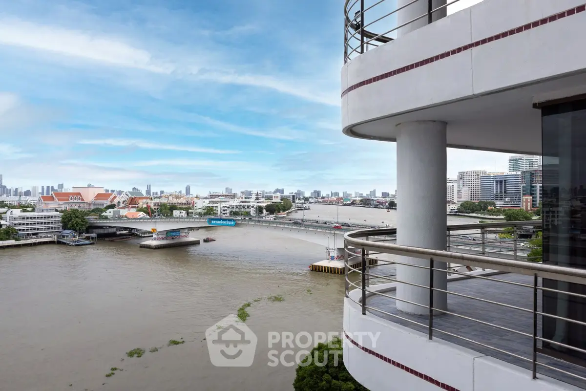 Stunning river view from a modern apartment balcony with city skyline in the background.