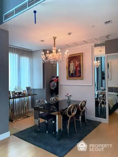 Elegant dining area with chandelier and modern decor in luxury apartment