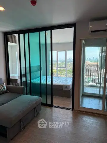 Modern apartment with sliding glass doors and city view from balcony