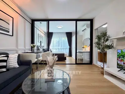 Modern living room with glass partition, stylish decor, and cozy ambiance