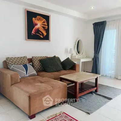 Cozy living room with stylish sofa and elegant decor, perfect for relaxation.