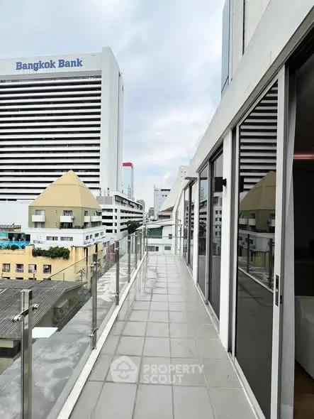 Modern balcony with city view and glass railing in urban setting