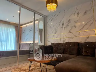 Luxurious living room with marble accent wall and plush seating in modern apartment.