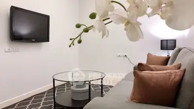 Cozy living room with modern decor and wall-mounted TV