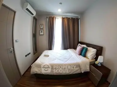 Cozy bedroom with modern decor and natural light, featuring a comfortable bed and stylish furnishings.