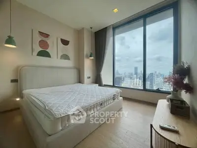 Spacious bedroom with large window offering stunning city view