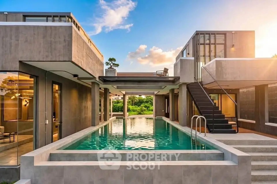 Luxurious modern villa with stunning pool and contemporary architecture at sunset.