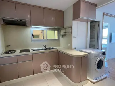 Modern kitchen with sleek cabinetry and built-in washing machine