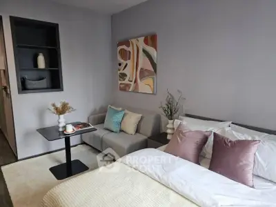 Modern bedroom with stylish decor and cozy seating area, perfect for relaxation.