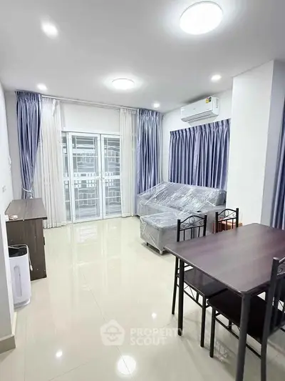 Modern living room with sleek furniture and large windows in a contemporary apartment.
