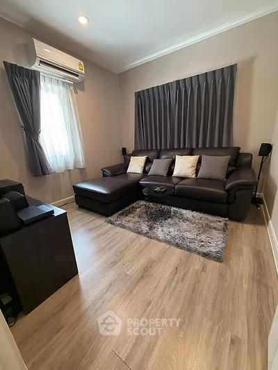 Cozy living room with modern decor and plush seating in a stylish apartment.