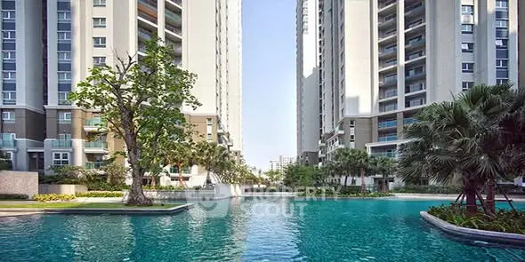 Luxurious residential complex with stunning pool and modern high-rise buildings.