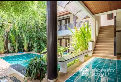 Tropical oasis with lush garden and inviting pool, perfect for relaxation and outdoor enjoyment.