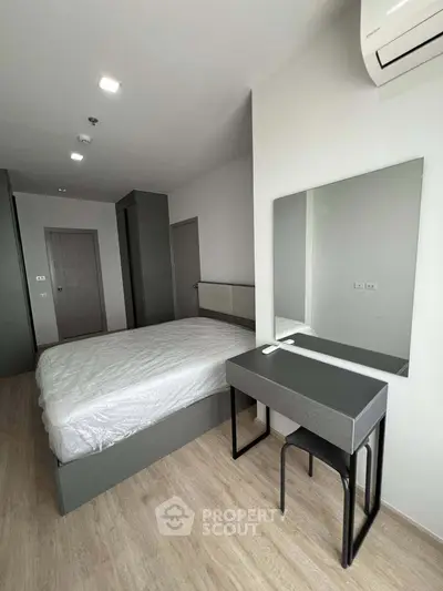 Modern bedroom with sleek furniture and air conditioning in a stylish apartment.