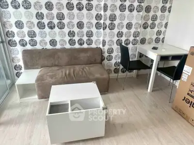 Modern living room with stylish wallpaper and minimalist furniture in a cozy apartment.