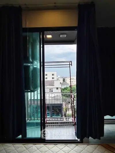 Cozy apartment with balcony view overlooking cityscape, perfect for urban living.