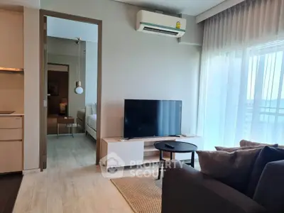 Modern living room with TV, air conditioning, and balcony view in a stylish apartment.