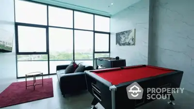 Luxurious game room with pool table and modern decor in high-rise apartment