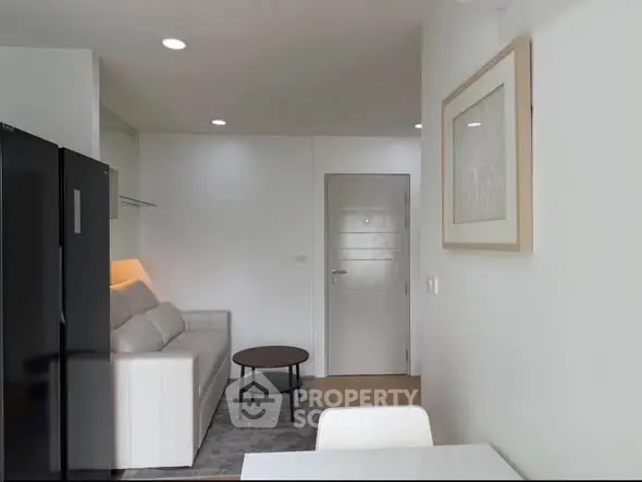 Modern living room with sleek design and cozy ambiance, featuring a white sofa and stylish decor.