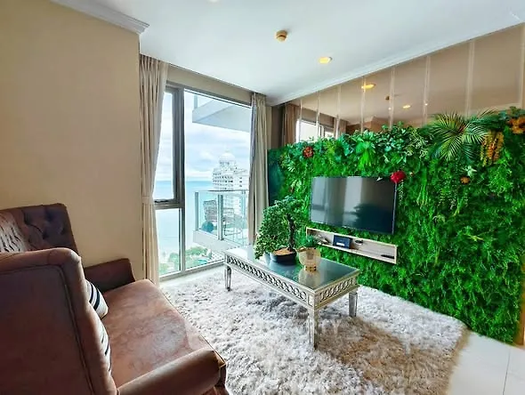 Luxurious living room with ocean view and lush green wall decor
