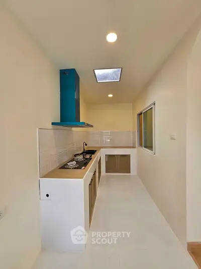 Modern kitchen with sleek design and gas stove in a compact layout