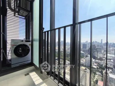 Stunning city view from high-rise balcony with washing machine setup.