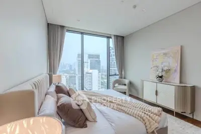 Luxurious bedroom with city view and elegant decor in high-rise apartment