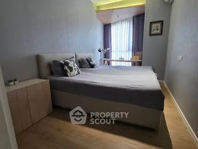 Modern bedroom with stylish decor and natural light, featuring a comfortable bed and elegant furnishings.