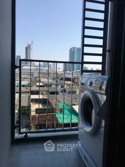 Urban balcony with washing machine and city view, perfect for modern living.
