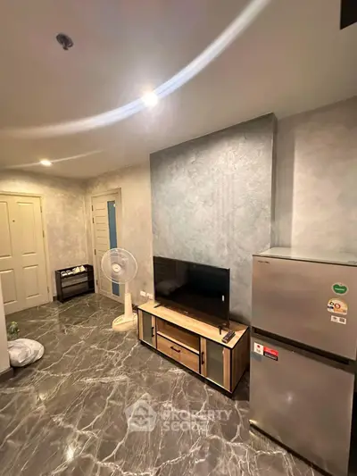 Modern living room with sleek marble flooring and stylish TV setup