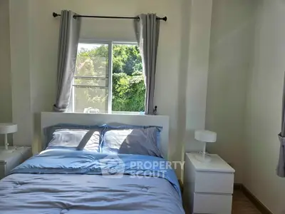 Cozy bedroom with natural light and modern decor, featuring a comfortable bed and stylish nightstands.