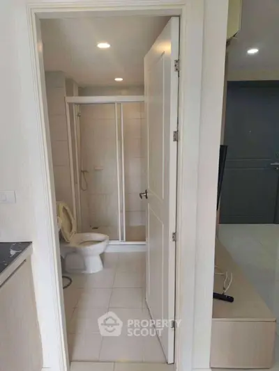 Compact bathroom with shower and toilet in modern apartment