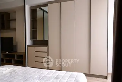 Modern bedroom with sleek wardrobe and cozy bed in stylish apartment.