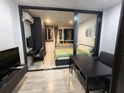 Modern studio apartment with sleek design, featuring a cozy bedroom and stylish living area.