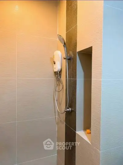 Modern bathroom shower with sleek design and built-in shelf