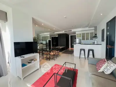 Modern open-plan living room with sleek kitchen and stylish decor